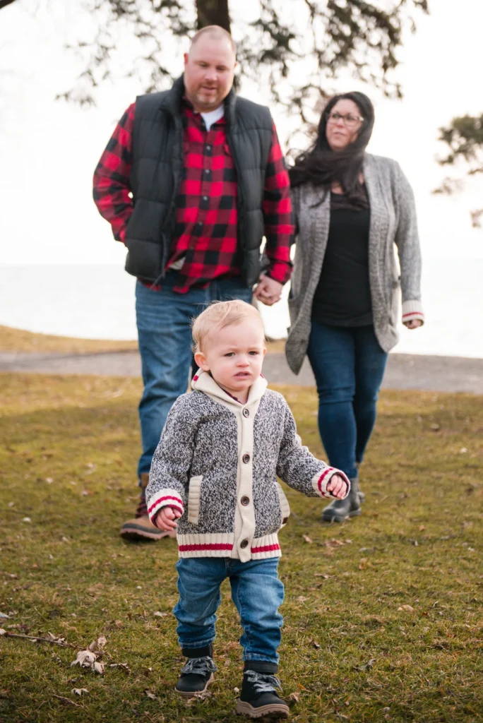 a couple walks behind their little boy - a family portrait shot at Paletta Mansion in Burlington, Ontario
