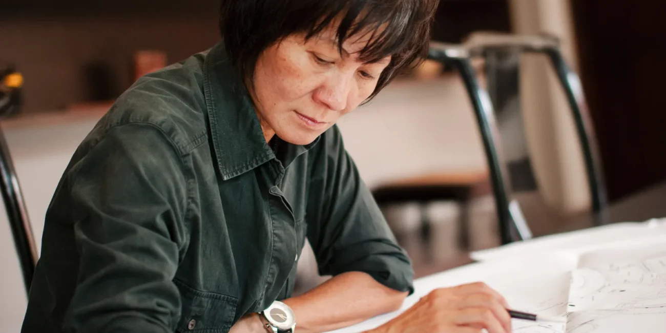 an interior designer looks over her drawings - a headshot shot by hamilton headshot photographer : Pixelesque Photography