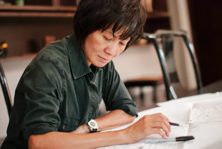 an interior designer looks over her drawings - a headshot shot by hamilton headshot photographer : Pixelesque Photography