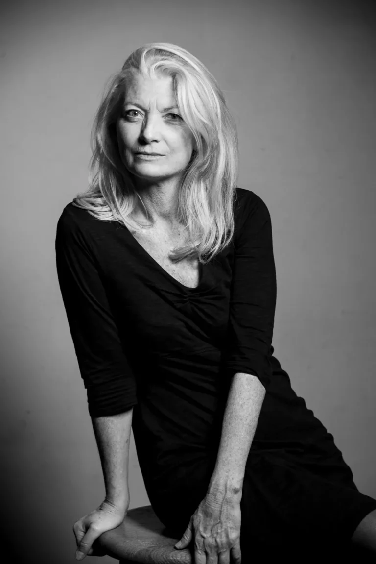 a woman sits on a chair and intensely stares at the camera - a headshot shot by Hamilton headshot photographer : Pixelesque Photography