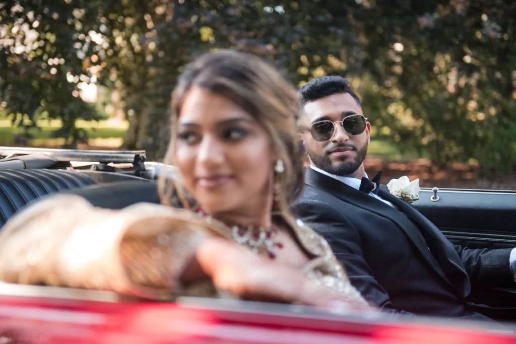 Plan Your Perfect Wedding Timeline 7 A groom looks at his bride in the passenger seat of a classic car. Shot at Gairloch Gardens by Pixelesque Photography - Hamilton Wedding Photographer.