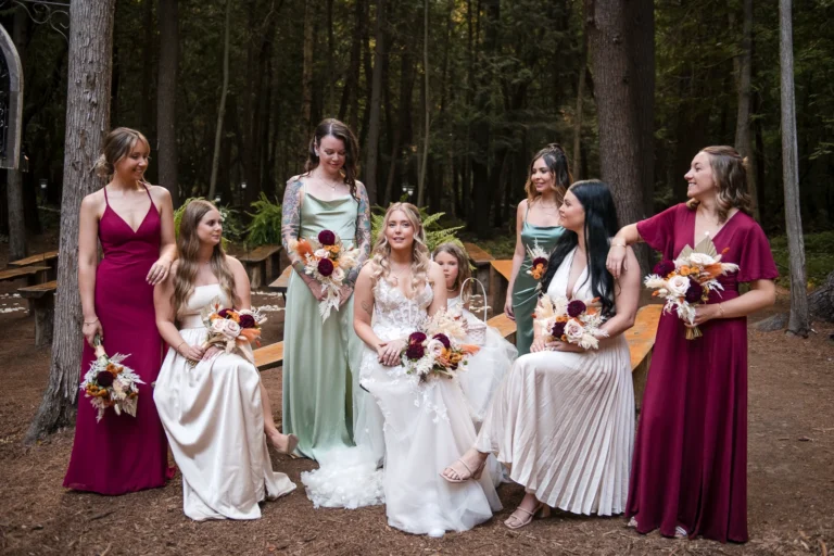 A bride and her bridesmaids pose in the woods after the ceremony. Shot at Whispering Springs by Pixelesque Photography - Hamilton Wedding Photographer.