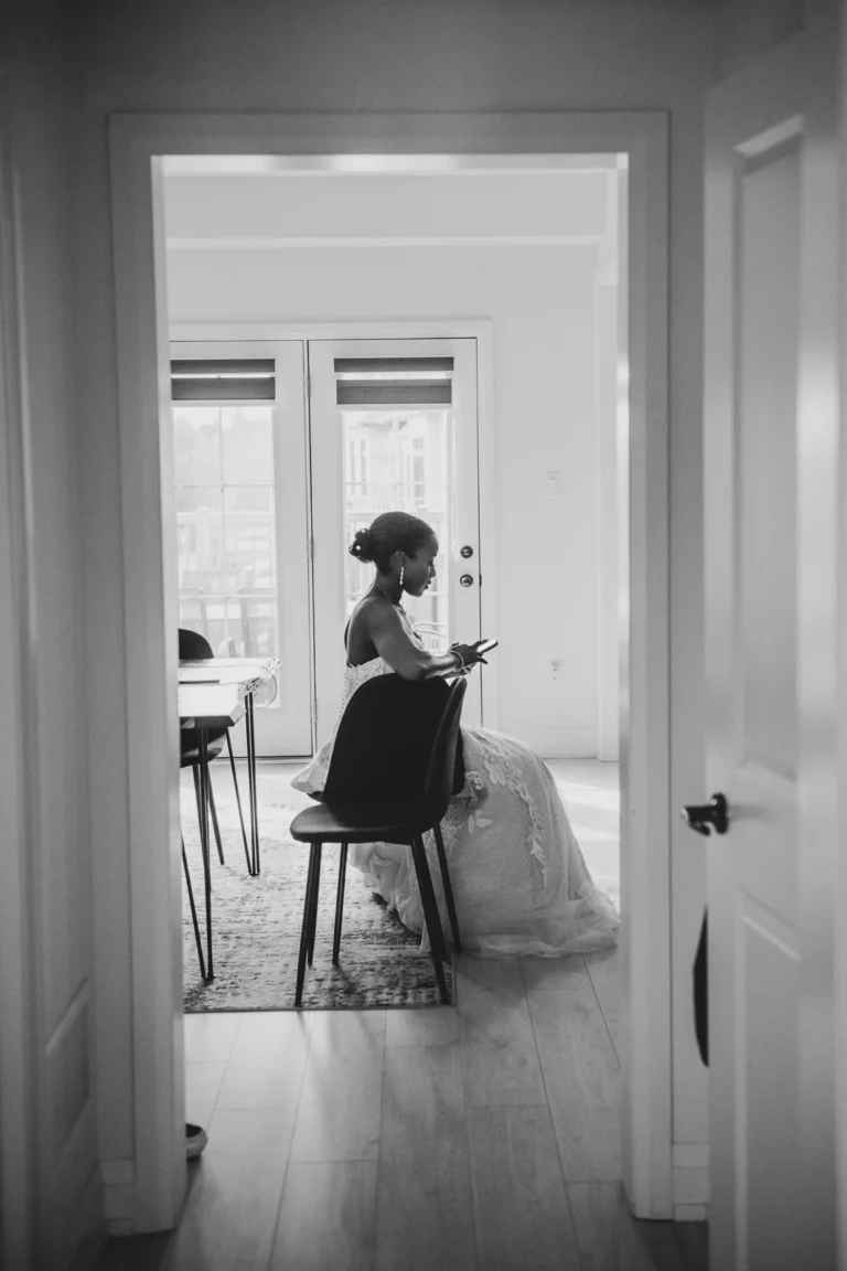 A bride has a quiet moment with her phone before the day begins. Shot by Pixelesque Photography - Hamilton Wedding Photographer.