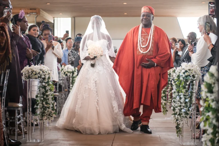 The bride and her father walk down the aisle in Traditional Nigerian Garb. Shot at Guild Inn Estate, Scarborough by Pixelesque Photography - Hamilton Wedding Photographer.