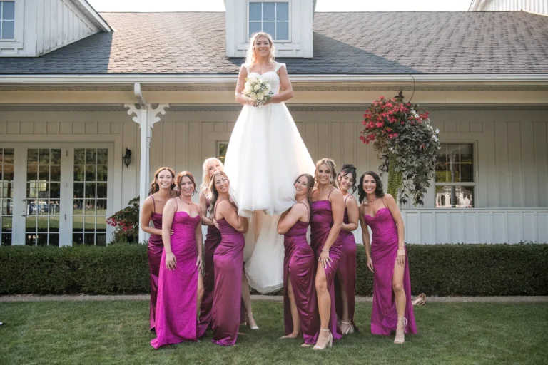 Gymnast bridesmaids hold up the bride over their shoulders. Shot at CopeTown Woods Golf Club by Pixelesque Photography - Hamilton Wedding Photographer.