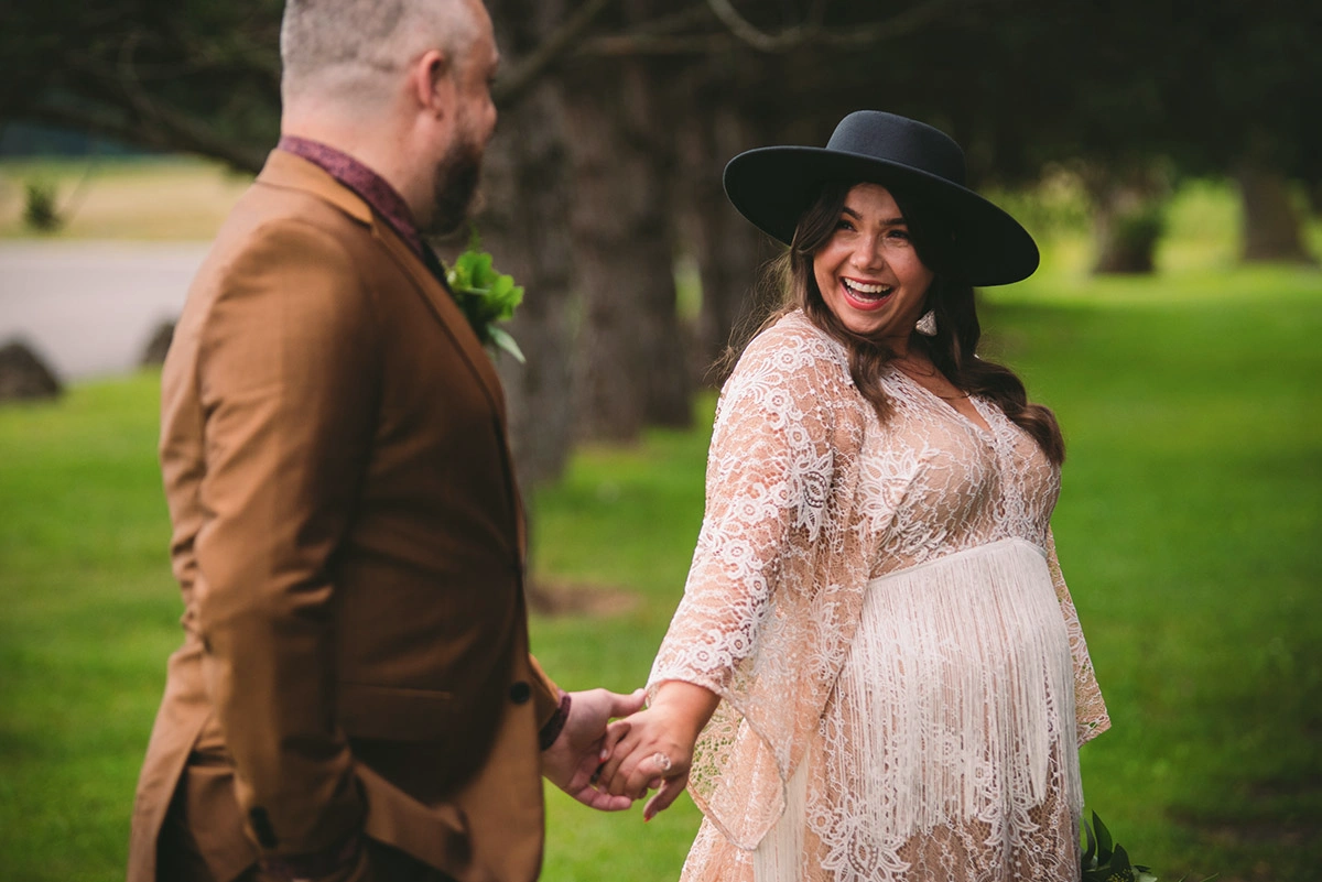 a bride looks at her groom as they go for a stroll. Shot by Pixelesque Photography - Hamilton Wedding Photographer.