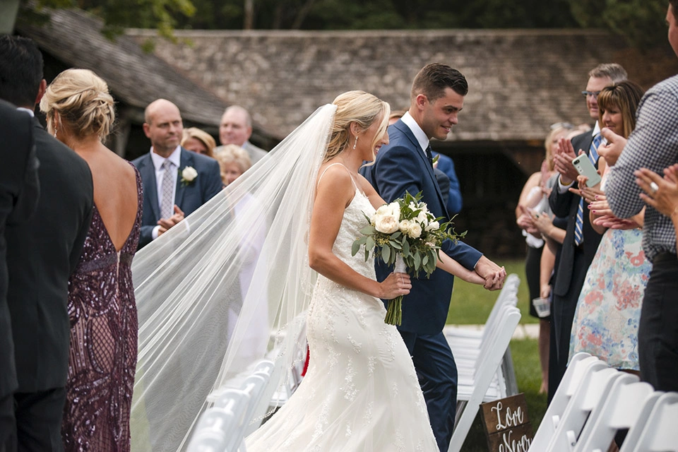 the bride and groom retreat down the aisle having just been married. Shot by Pixelesque Photography - Hamilton Wedding Photographer.