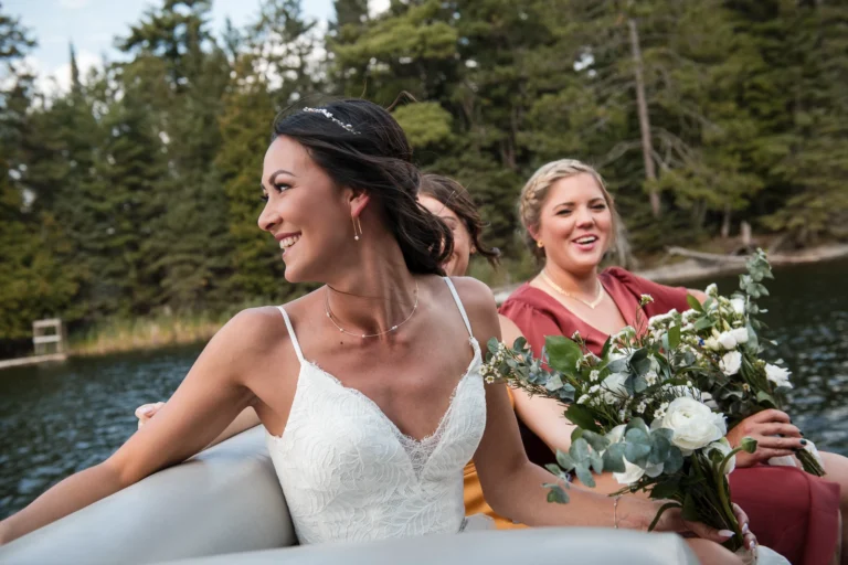 A bride looks over the edge of her boat as she goes to her wedding ceremony. Shot by Pixelesque Photography - Hamilton Wedding Photographer.