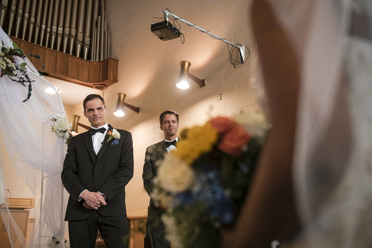 the groom looks at his bride walking down the aisle to him. Shot by Pixelesque Photography - Hamilton Wedding Photographer.