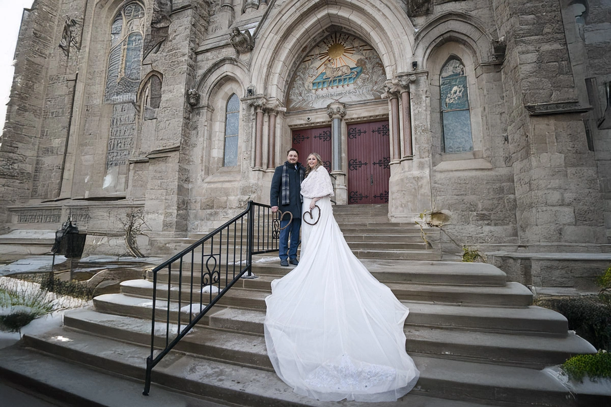 a couple stand on the stairs of a church having just been married. Shot by Pixelesque Photography - Hamilton Wedding Photographer.