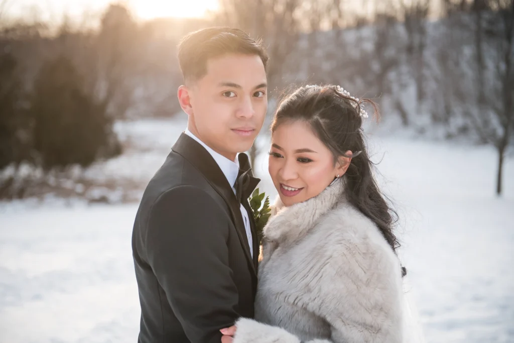 Plan Your Perfect Wedding Timeline 6 A bride and groom embrace in the snow. Shot by Pixelesque Photography - Hamilton Wedding Photographer.