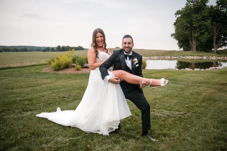 A groom plays his wife's leg like a guitar. Shot at Wakefield Estate by Pixelesque Photography - Hamilton Wedding Photographer.