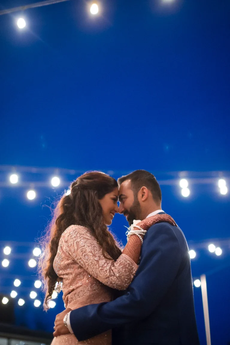 A bride and groom share a dance under twinkling fairy lights. Shot by Pixelesque Photography - Hamilton Wedding Photographer.