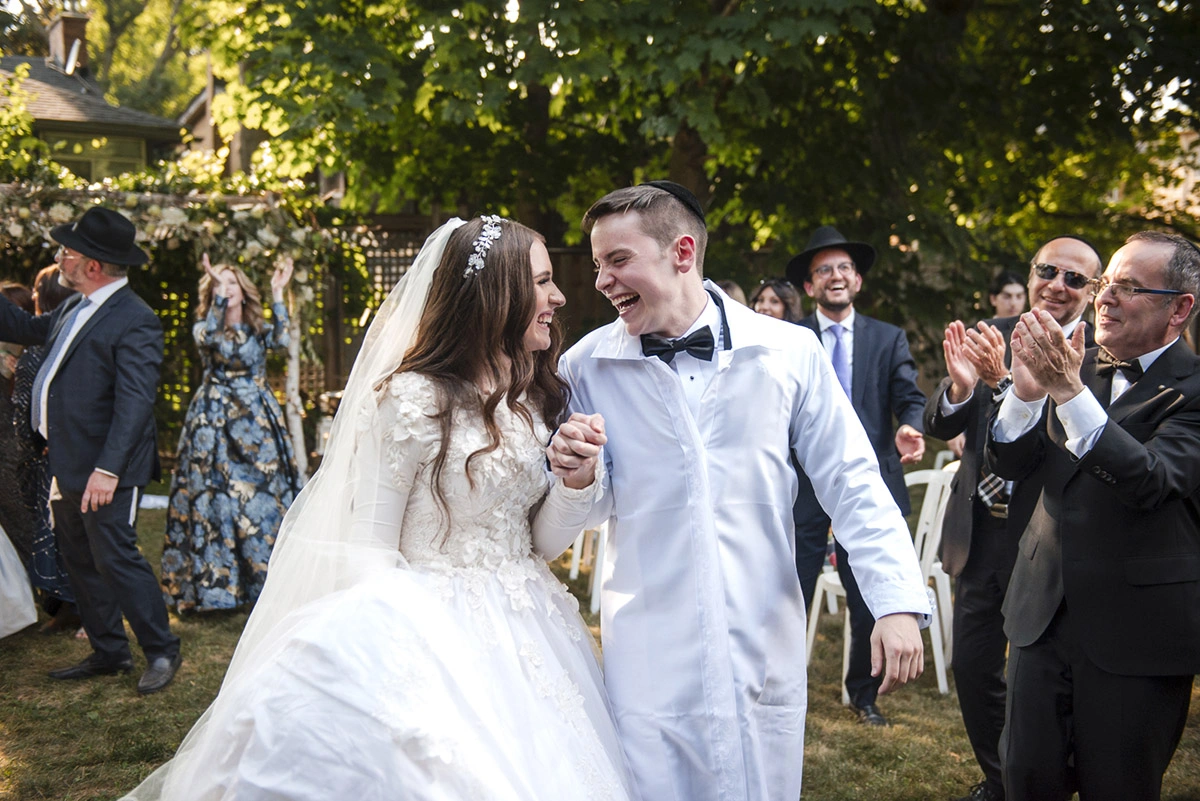 a newlywed couple joyfully walk back down the aisle . Shot by Pixelesque Photography - Hamilton Wedding Photographer.