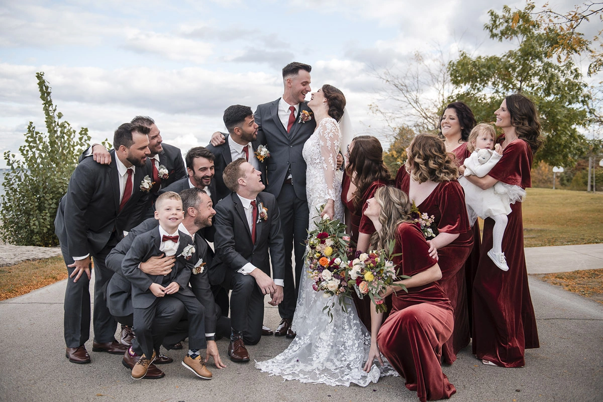 a wedding party gathers around the couple who look joyfully at each other. Shot by Pixelesque Photography - Hamilton Wedding Photographer.