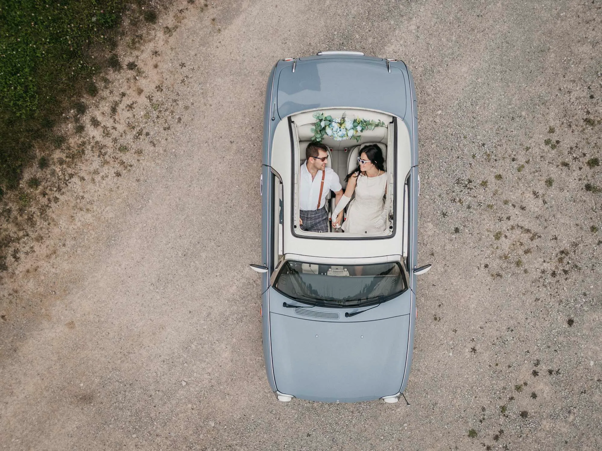 an aerial shot of the couple seen in a retro car through the open sunroof. engagement session photographed at 5 drive in Oakville Ontario by Pixelesque Photography, hamilton wedding photographer.