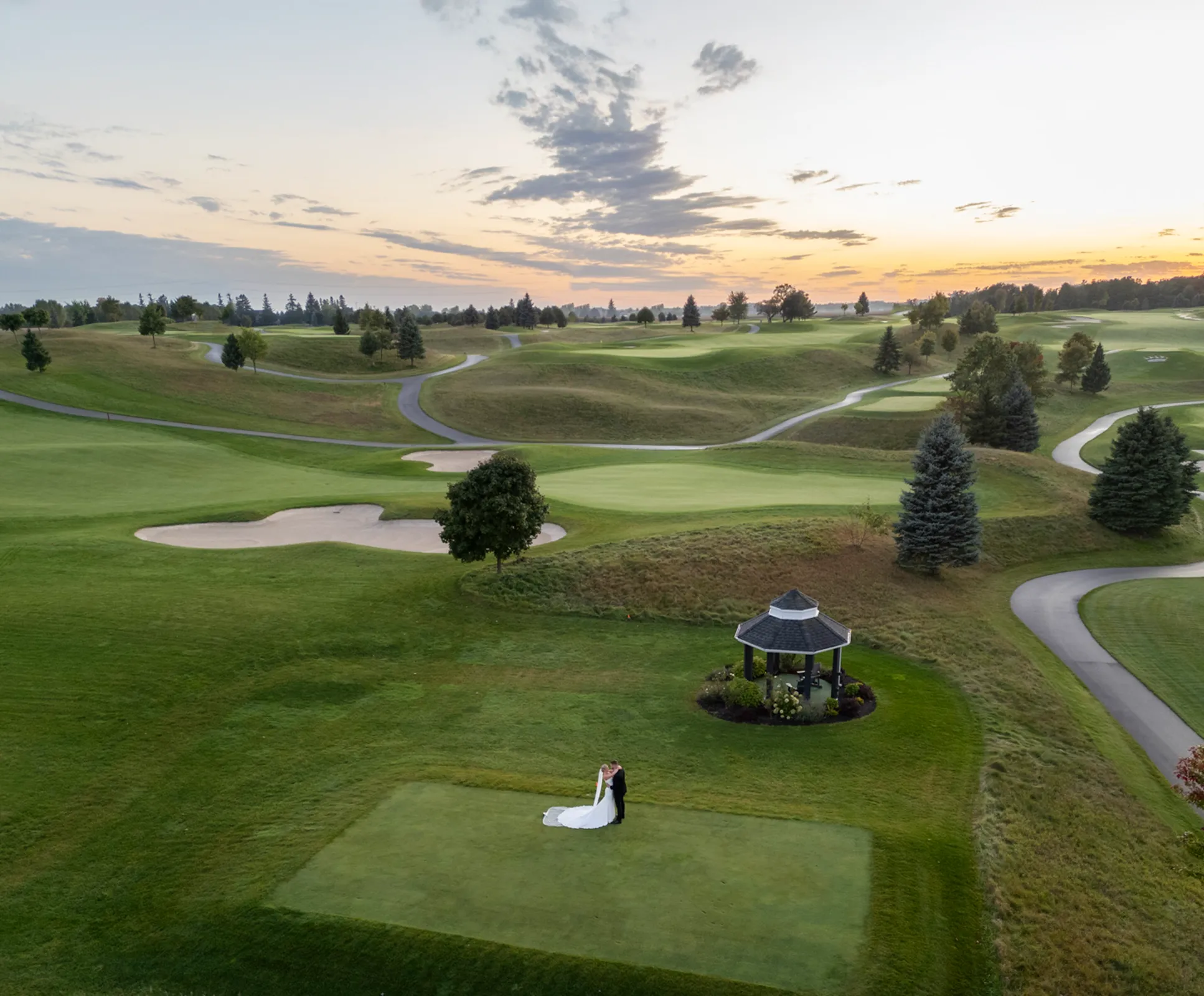 After the Rains : Kayla & Kyle's Whistle Bear Golf Club Wedding 28 a drone shot of the wedding couple embracing on a golf course. Shot at Whistle Bear Golf Club by Pixelesque Photography - Hamilton Wedding Photographer.
