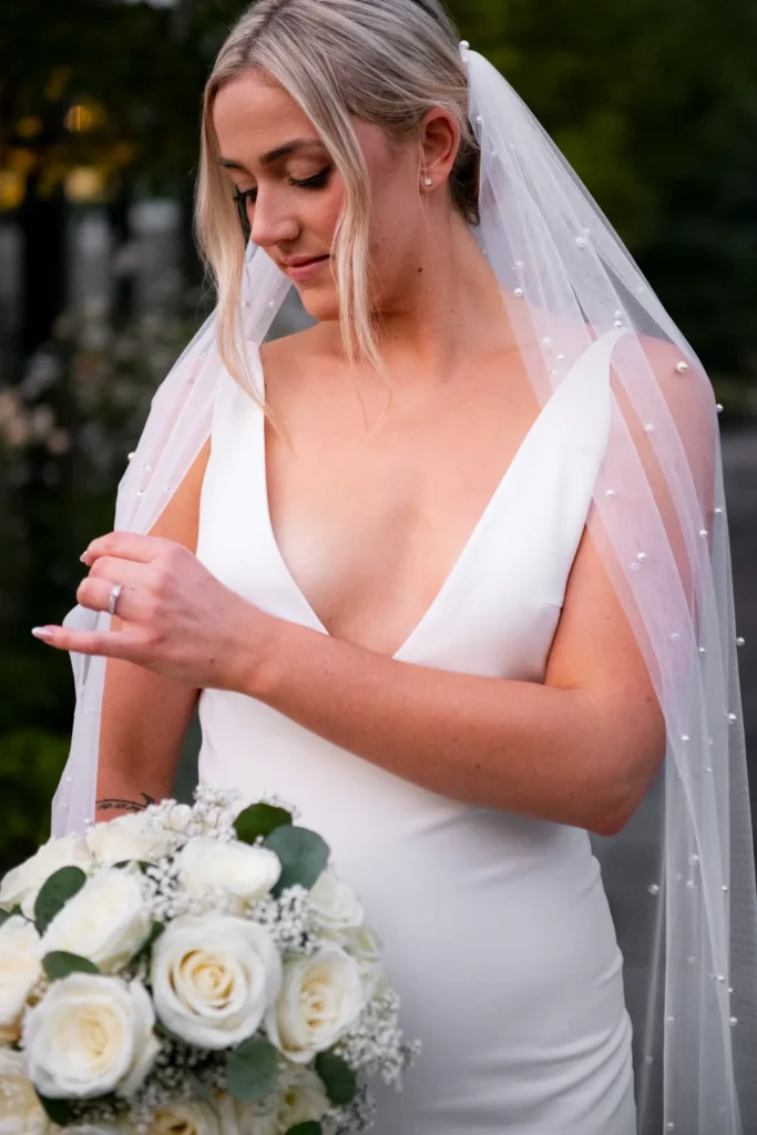 After the Rains : Kayla & Kyle's Whistle Bear Golf Club Wedding 30 the bride feels her veil in a garden. Shot at Whistle Bear Golf Club by Pixelesque Photography - Hamilton Wedding Photographer.