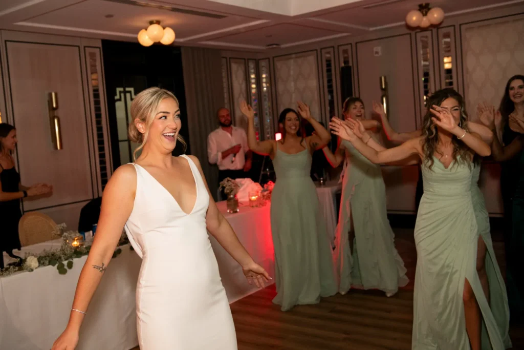 After the Rains : Kayla & Kyle's Whistle Bear Golf Club Wedding 36 the bride watches a flash mob of bridesmaids dance for her. Shot at Whistle Bear Golf Club by Pixelesque Photography - Hamilton Wedding Photographer.