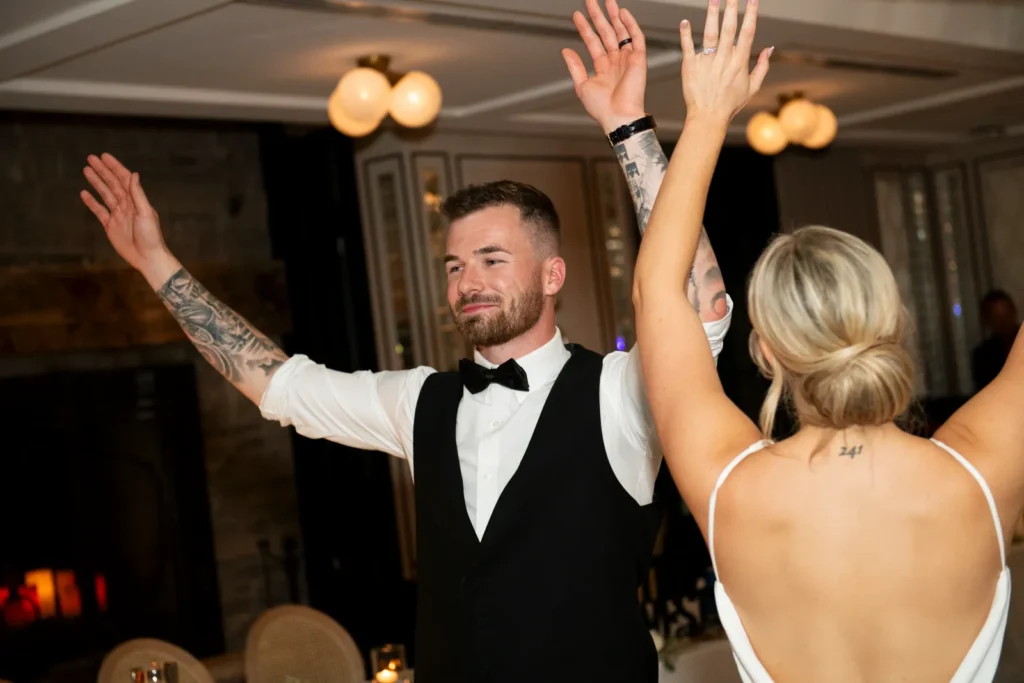 After the Rains : Kayla & Kyle's Whistle Bear Golf Club Wedding 37 A wedding couple wave their hands on the dance floor. Shot at Whistle Bear Golf Club by Pixelesque Photography - Hamilton Wedding Photographer.