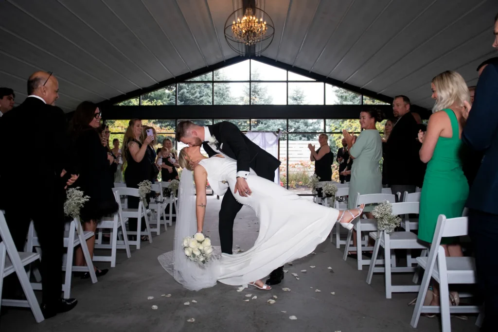 After the Rains : Kayla & Kyle's Whistle Bear Golf Club Wedding 12 the groom dips the bride as they walk back down the aisle after being married. Shot at Whistle Bear Golf Club by Pixelesque Photography - Hamilton Wedding Photographer.
