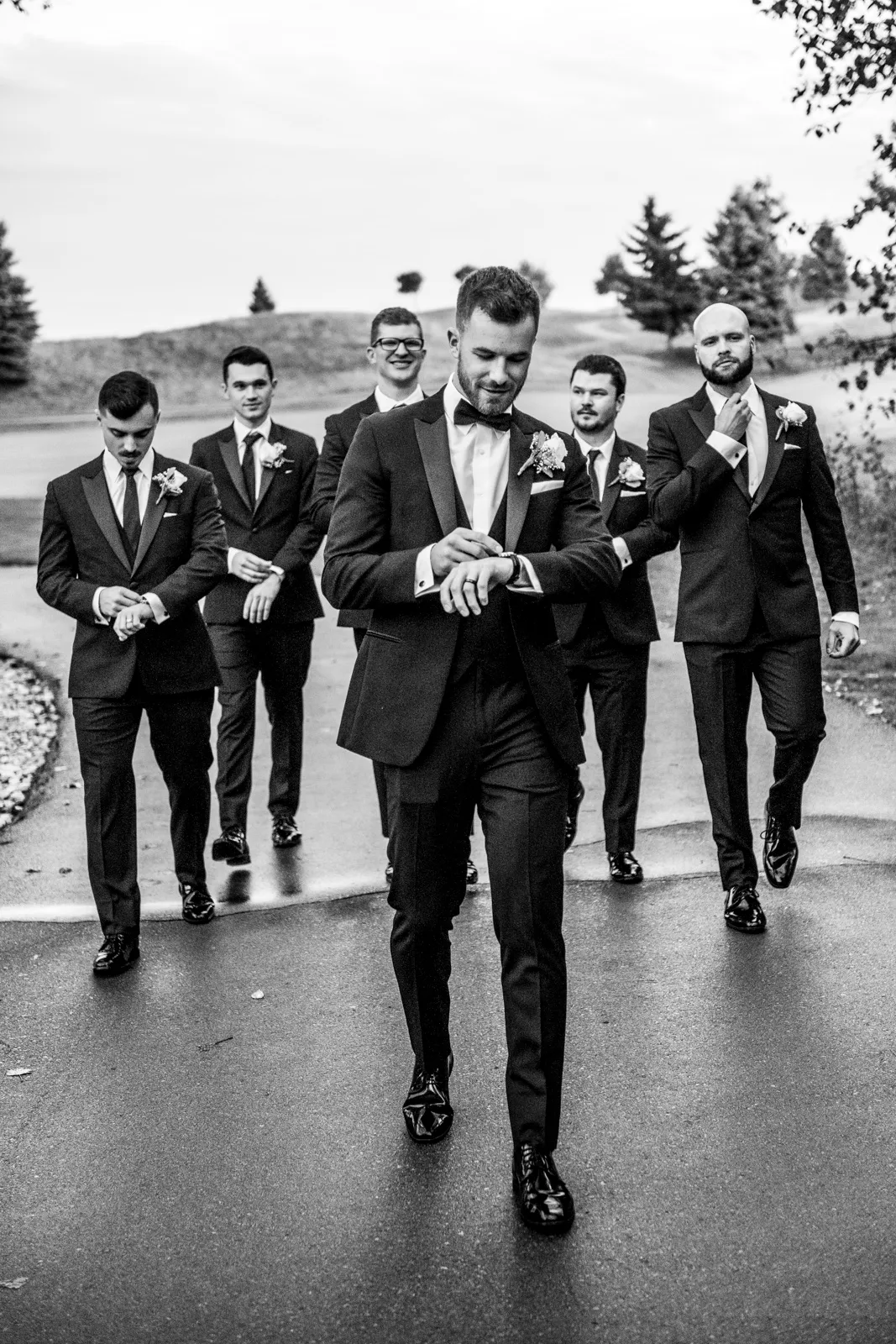 After the Rains : Kayla & Kyle's Whistle Bear Golf Club Wedding 21 the groomsmen walk behind the groom all looking very cool. Shot at Whistle Bear Golf Club by Pixelesque Photography - Hamilton Wedding Photographer.