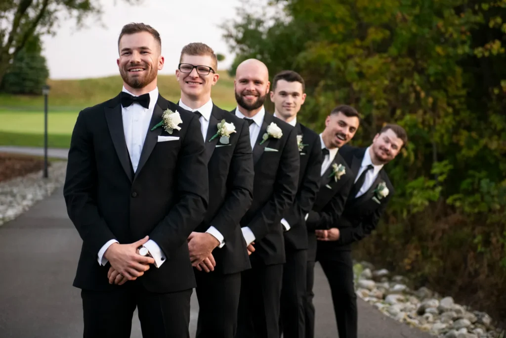 groomsmen fan out from behind the groom whimsicaclly. Shot at Whistle Bear Golf Club by Pixelesque Photography - Hamilton Wedding Photographer.