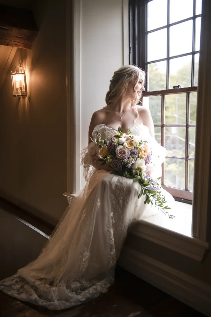 a bride site at a window sill looking out - shot at ancaster mill - hamilton wedding venue - shot by hamilton wedding photographer- Pixelesque Photography