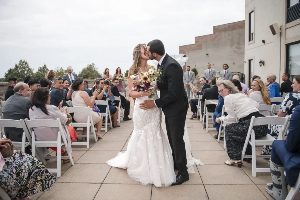 a couple share a kiss at the end of the aisle after their wedding at C hotel by carmens - hamilton wedding venue - shot by hamilton wedding photographer- Pixelesque Photography