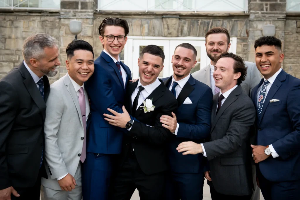 the groom and his groomsmen share a laugh. One of many beautiful moments from a wedding at Harding Waterfront Estate in Oakville, by Pixelesque Photography - Hamilton Wedding Photographer.