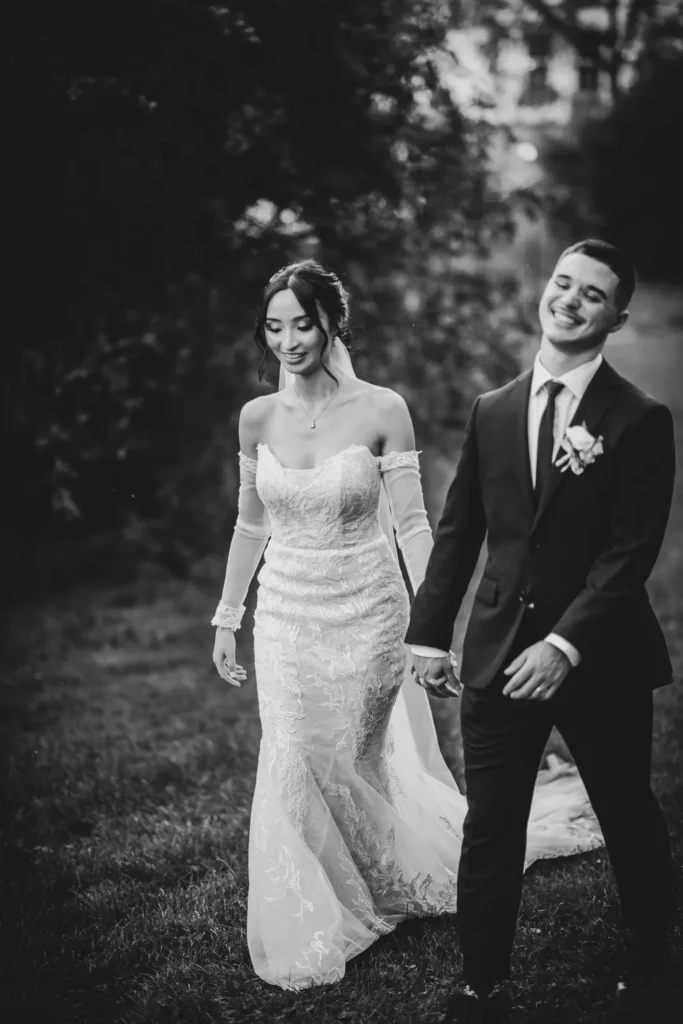 the couple walk hand in hand in joy. One of many beautiful moments from a wedding at Harding Waterfront Estate in Oakville, by Pixelesque Photography - Hamilton Wedding Photographer.