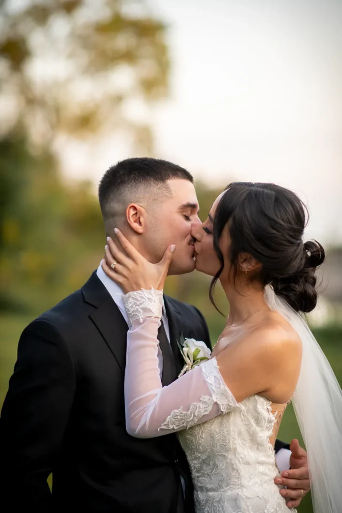 the couple share a kiss. One of many beautiful moments from a wedding at Harding Waterfront Estate in Oakville, by Pixelesque Photography - Hamilton Wedding Photographer.
