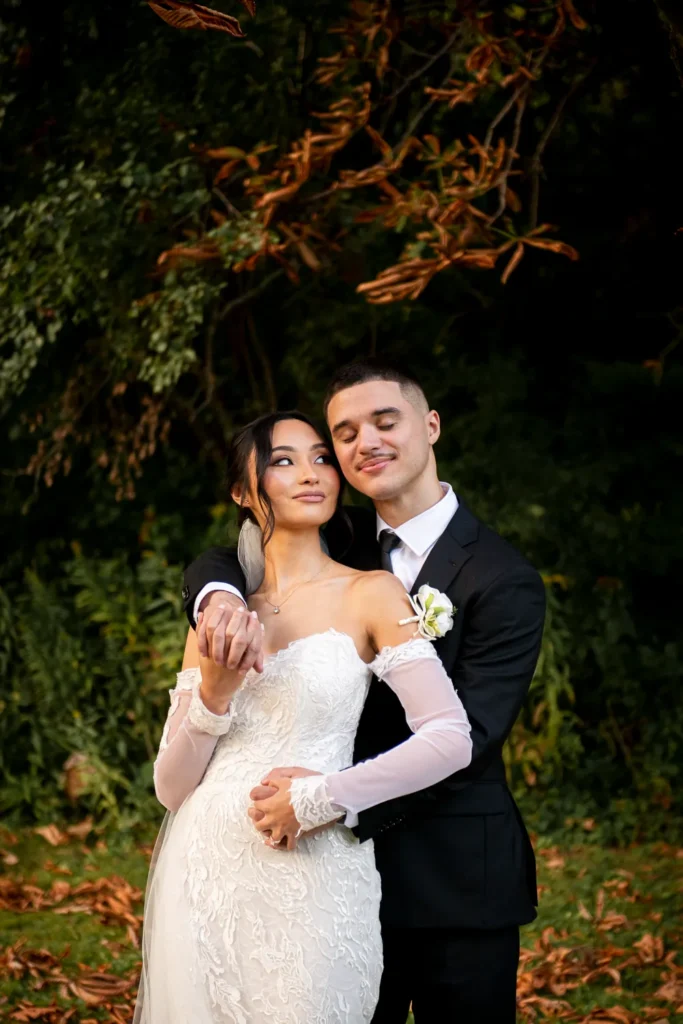 the bride looks lovingly at her husband as they embrace. One of many beautiful moments from a wedding at Harding Waterfront Estate in Oakville, by Pixelesque Photography - Hamilton Wedding Photographer.