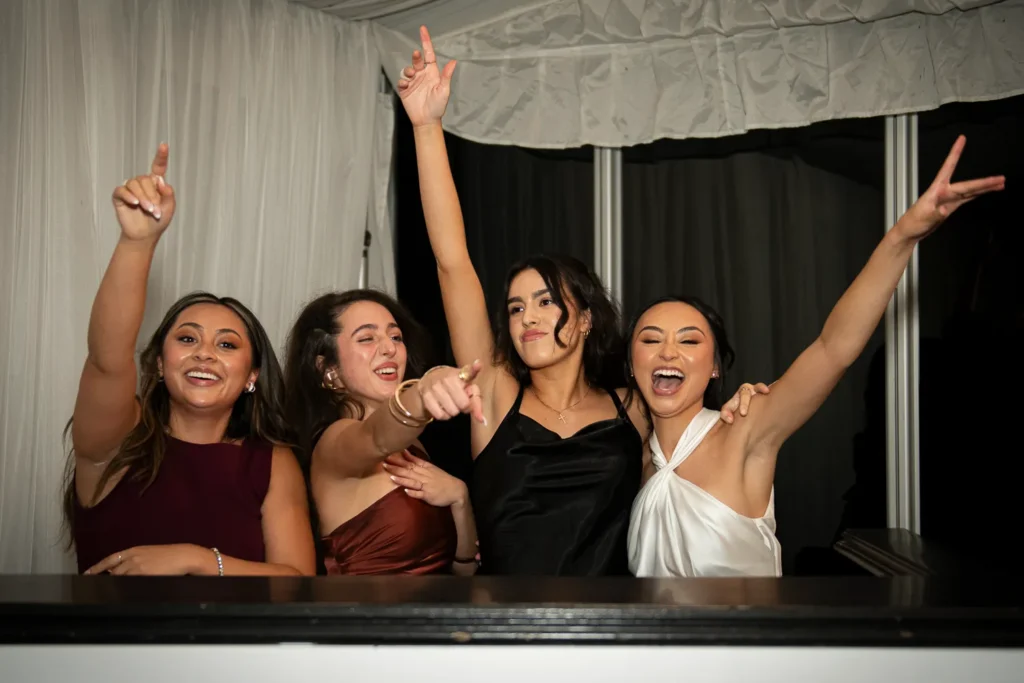 the bride and her friends take over the dj booth. One of many beautiful moments from a wedding at Harding Waterfront Estate in Oakville, by Pixelesque Photography - Hamilton Wedding Photographer.