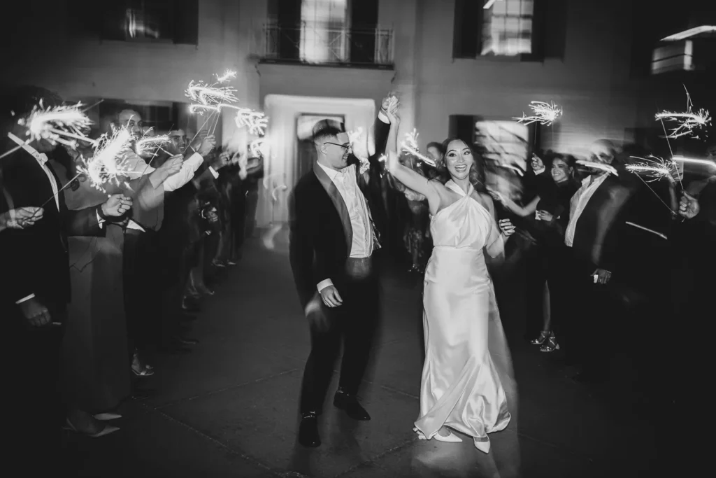 the groom spins his bride during the sparkler exit. One of many beautiful moments from a wedding at Harding Waterfront Estate in Oakville, by Pixelesque Photography - Hamilton Wedding Photographer.