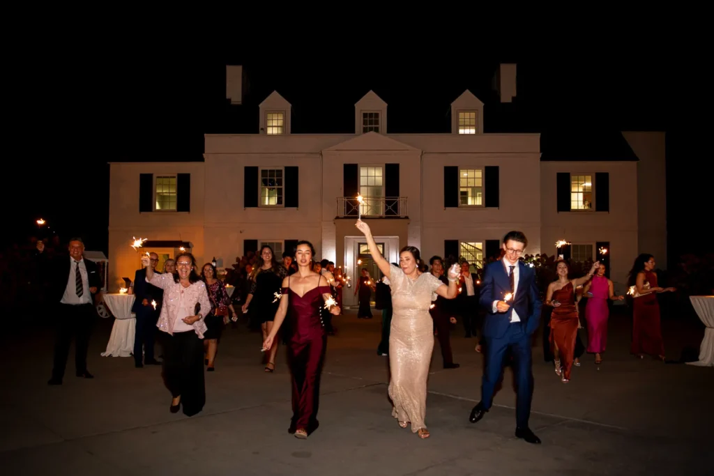 family and friends during the sparkler exit at the end of the night. One of many beautiful moments from a wedding at Harding Waterfront Estate in Oakville, by Pixelesque Photography - Hamilton Wedding Photographer.