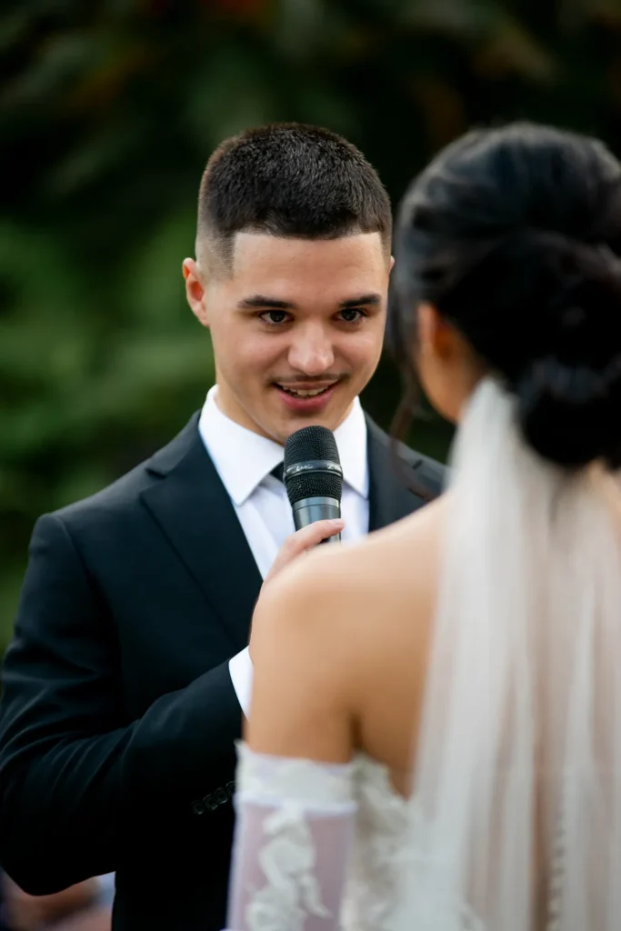the groom reads his vows to his bride. One of many beautiful moments from a wedding at Harding Waterfront Estate in Oakville, by Pixelesque Photography - Hamilton Wedding Photographer.