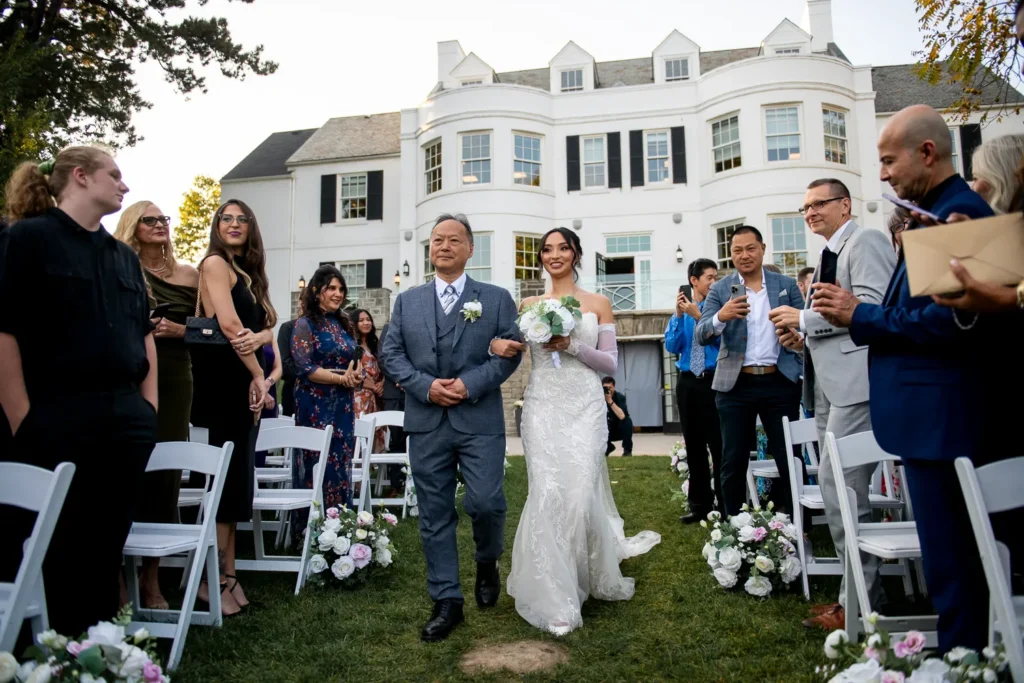 the bride walks down the aisle to her groom. One of many beautiful moments from a wedding at Harding Waterfront Estate in Oakville, by Pixelesque Photography - Hamilton Wedding Photographer.