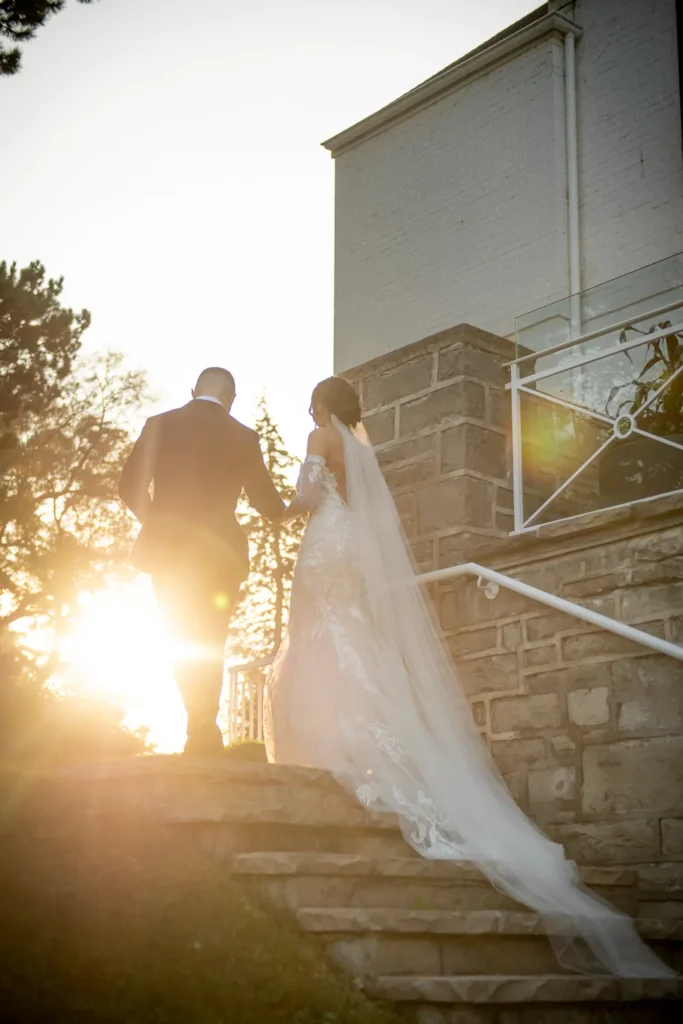 the couple walk off into the sunset. One of many beautiful moments from a wedding at Harding Waterfront Estate in Oakville, by Pixelesque Photography - Hamilton Wedding Photographer.