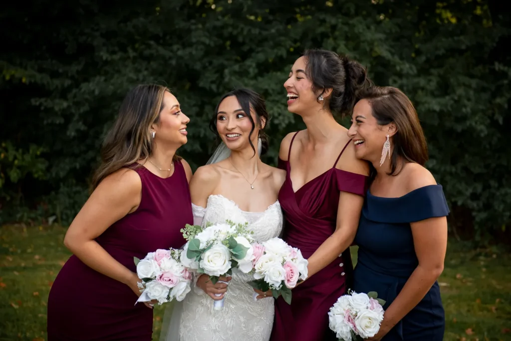 the bride and some bridesmaids being playful. One of many beautiful moments from a wedding at Harding Waterfront Estate in Oakville, by Pixelesque Photography - Hamilton Wedding Photographer.