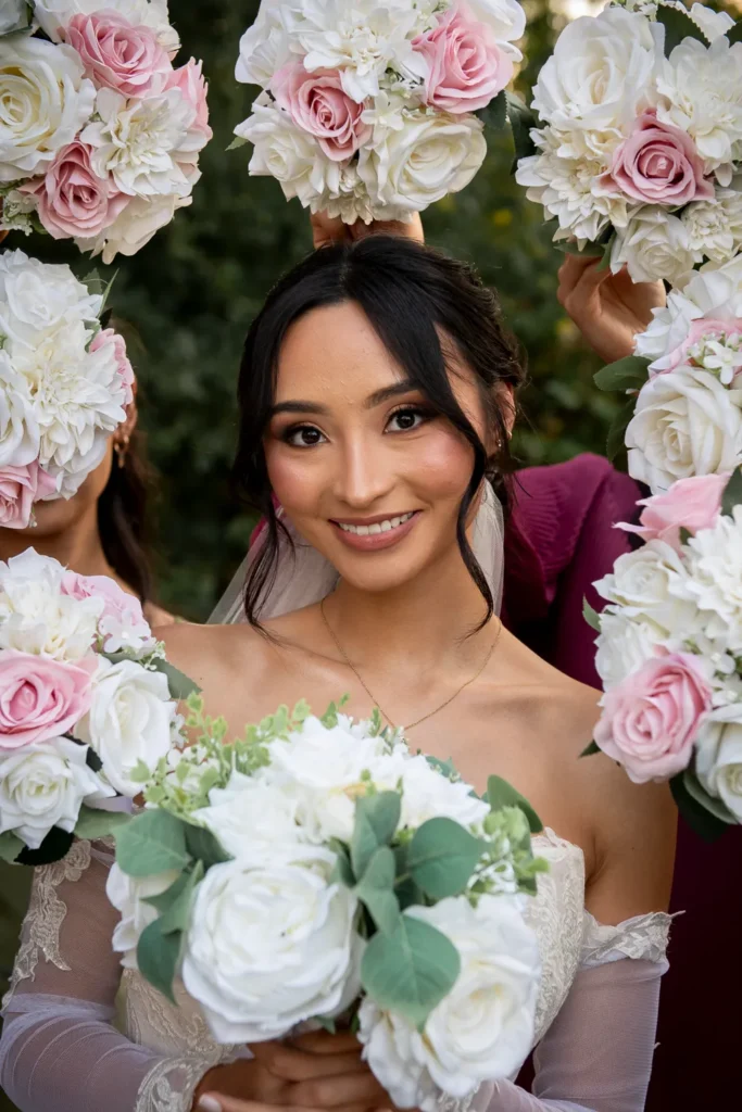 the bride framed by bouqets. One of many beautiful moments from a wedding at Harding Waterfront Estate in Oakville, by Pixelesque Photography - Hamilton Wedding Photographer.
