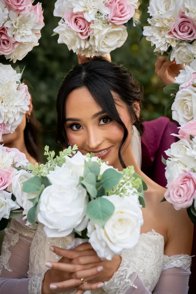 the bride framed by bouqets. One of many beautiful moments from a wedding at Harding Waterfront Estate in Oakville, by Pixelesque Photography - Hamilton Wedding Photographer.