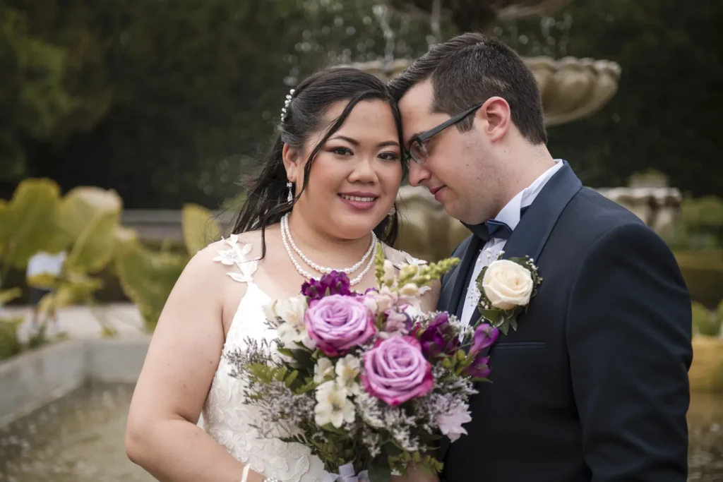 a groom knocks his gently against his bride's temple - shot at the royal botanical gardens - hamilton wedding venue - shot by hamilton wedding photographer- Pixelesque Photography