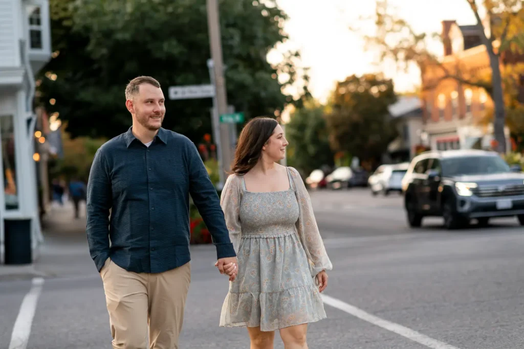 a couple cross the road hand in hand. Part of an engagement shoot Shot in Niagara-on-the-lake by Pixelesque Photography.