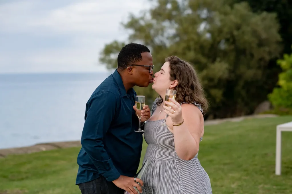 A couple drinking Champagne after a proposal photos at Konzelmann Estate in Niagara-on-the-Lake