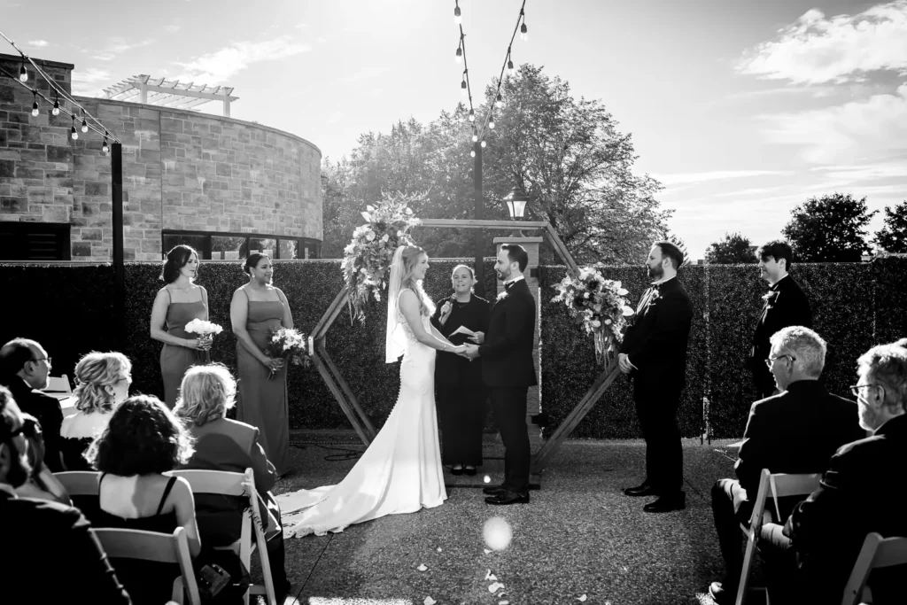 the bride, groom, bridal party, and officiant stand at the head of the wedding. Shot at Carmen's event centre, Hamilton by Pixelesque Photography.