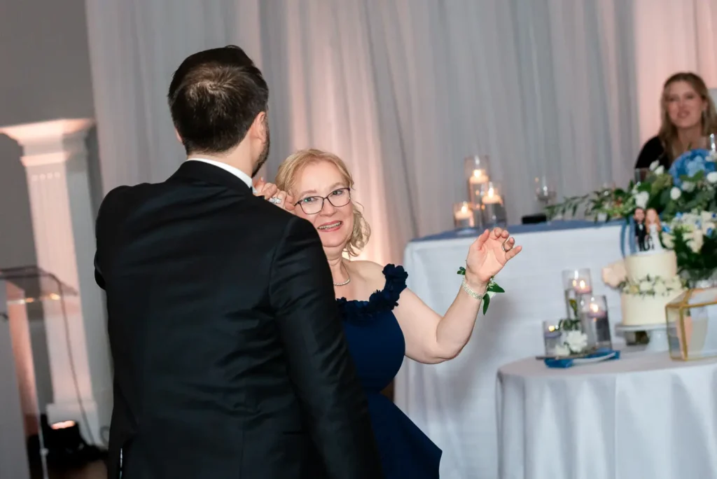 a groom spins his mother as they dance. Shot at Carmen's Event Centre, Hamilton by Pixelesque Photography.