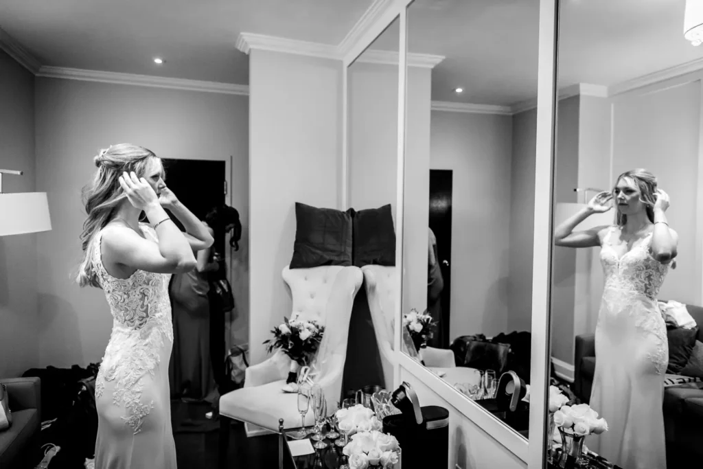 the bride checks herself out in the mirror. Shot at Carmen's event centre, Hamilton by Pixelesque Photography.