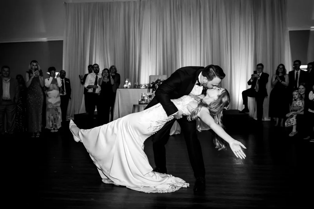 the wedding couple finish their first dance with a dip and a kiss. Shot at Carmen's Event Centre, Hamilton by Pixelesque Photography.