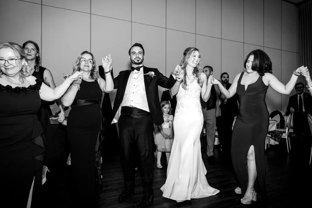 a wedding dance floor fills with people doing a traditional turkish dance. Shot at Carmen's Event Centre, Hamilton by Pixelesque Photography.